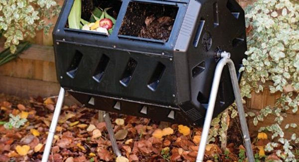 Split chamber tumbler compost bin with vegetables in the left half and usable compost in the right half.