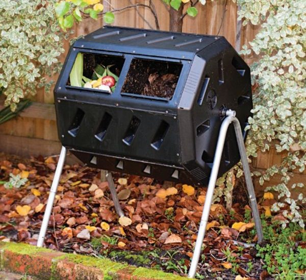 Split chamber tumbler compost bin with vegetables in the left half and usable compost in the right half.