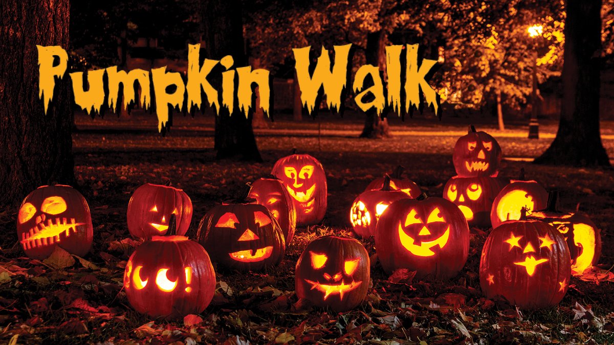 15 Jack O' Lanterns in a group in a dark wood area with top text Pumpkin Walk.